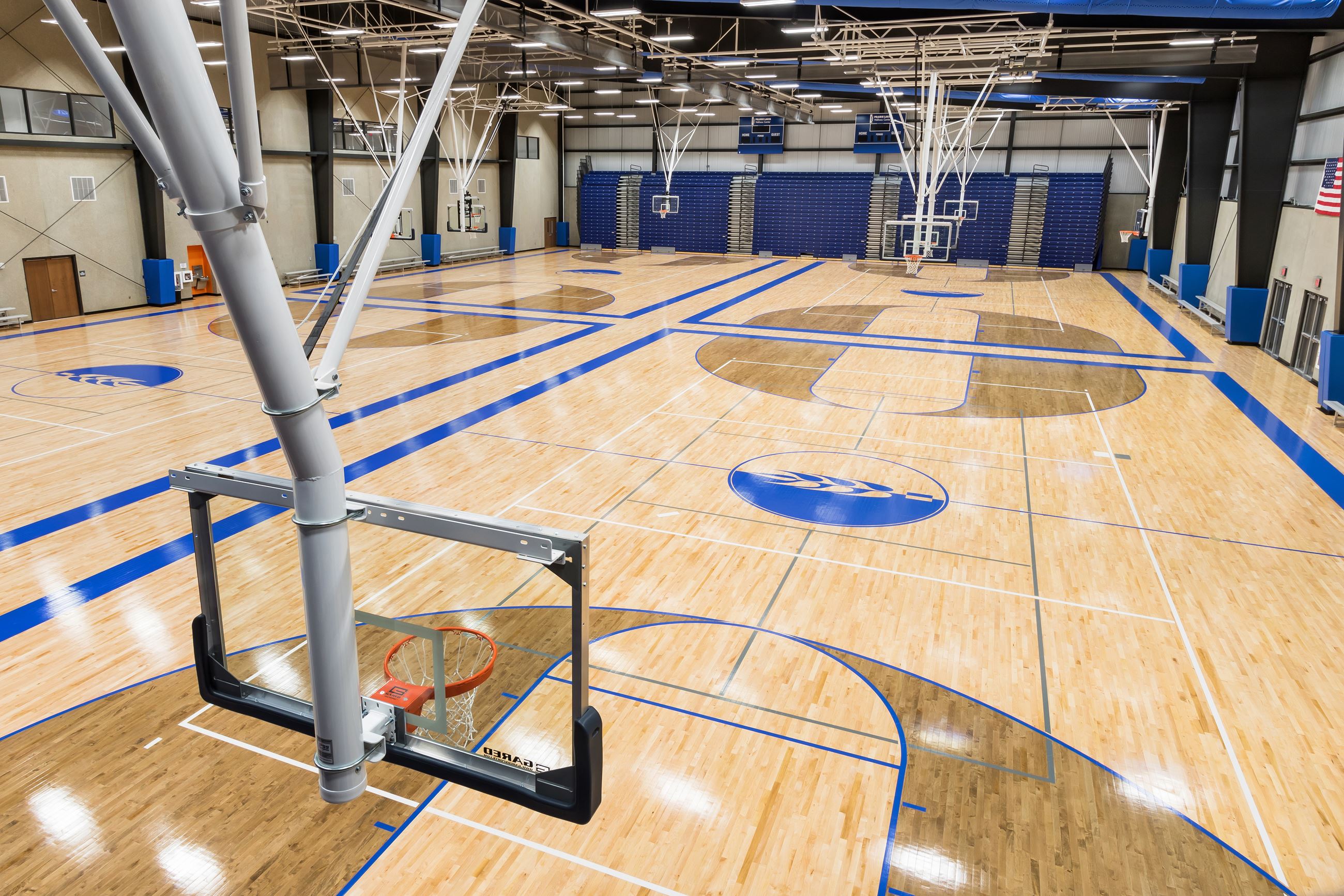 Two side-by-side indoor basketball courts
