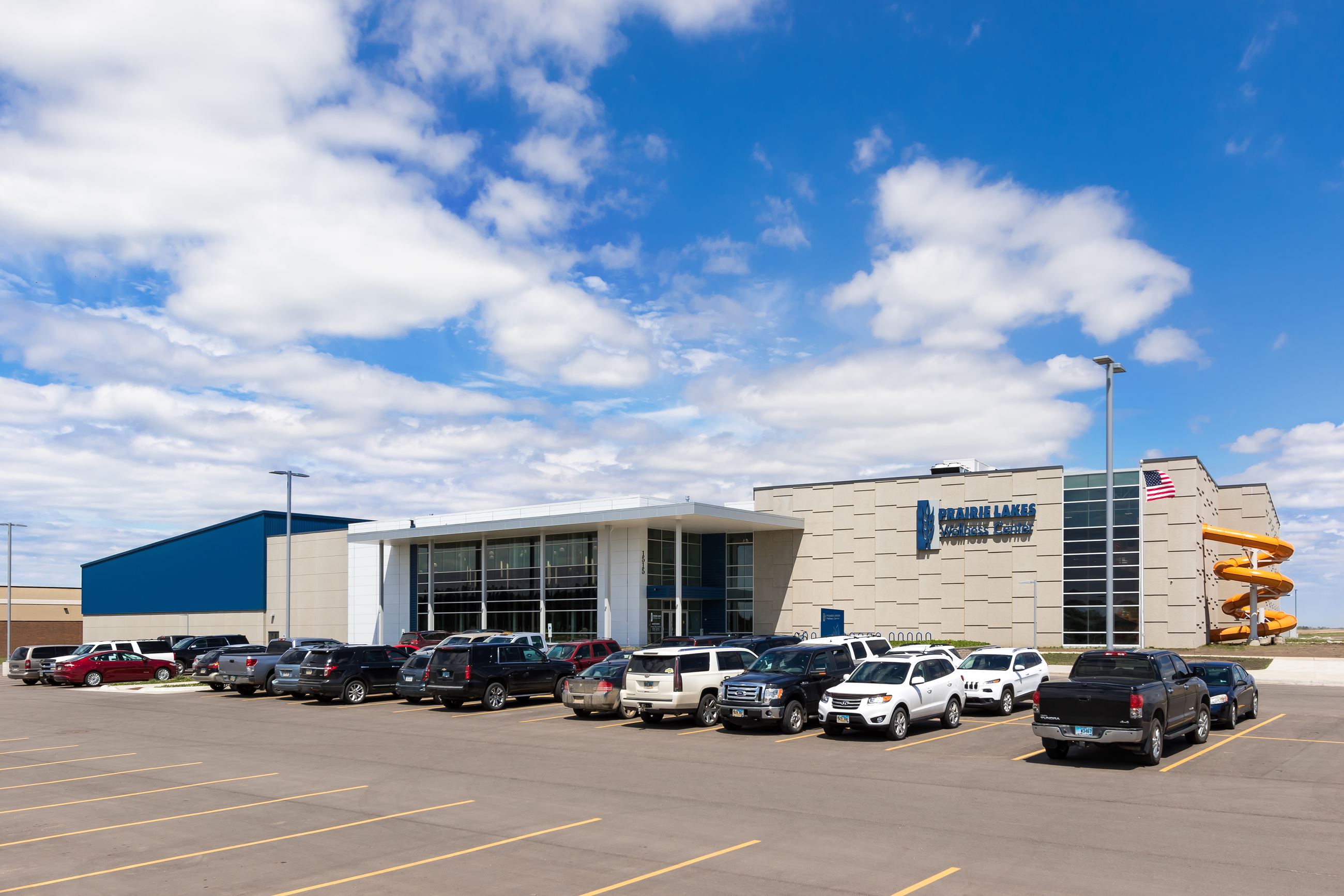 Cars parked in a parking lot outside of a fitness facilityPLWC17-1767